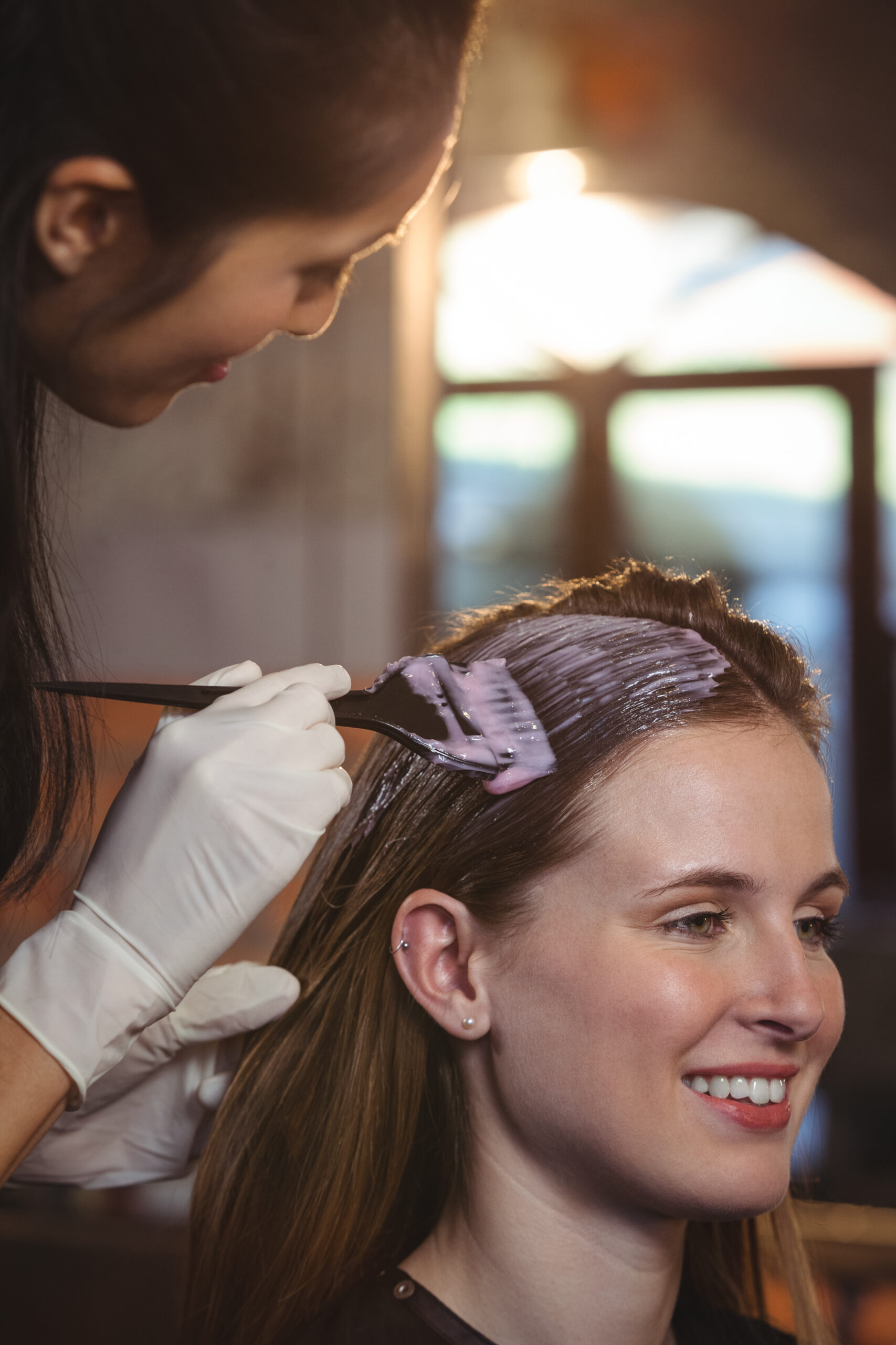 hairdresser dyeing hair her client scaled