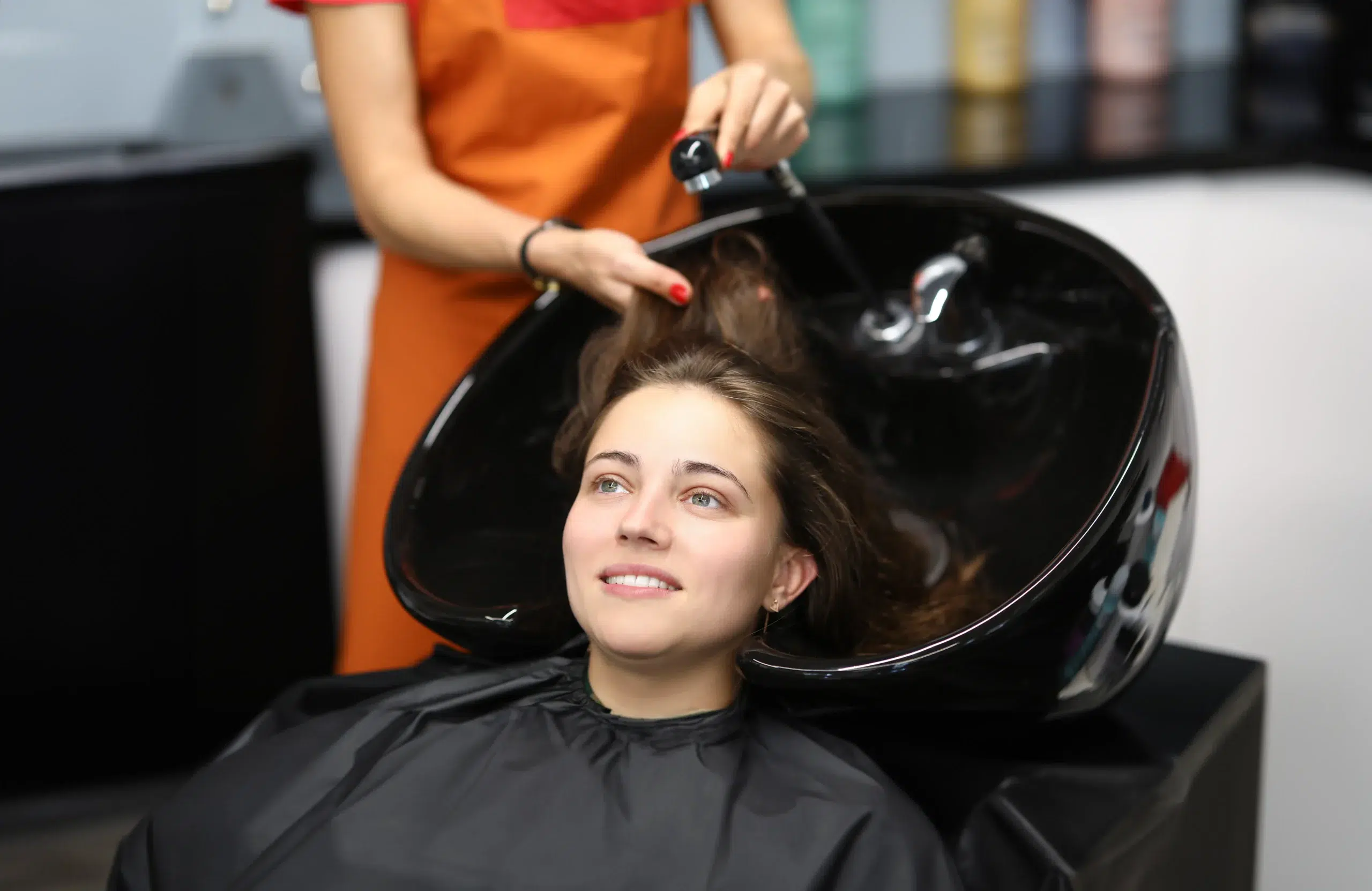 master washes her hair sink client hairdressing salon scaled